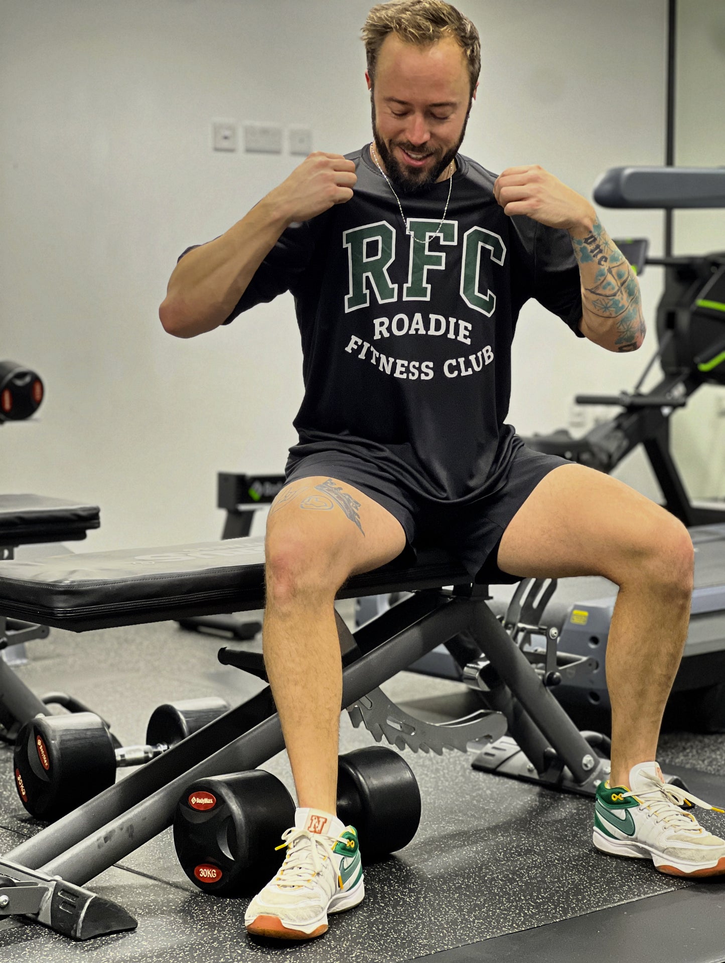 Man in a gym wearing an RFC Roadie Fitness Club t-shirt.